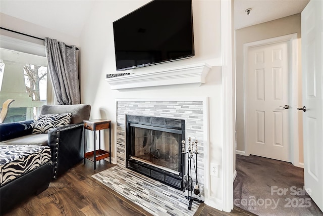 living room featuring a fireplace and dark hardwood / wood-style flooring