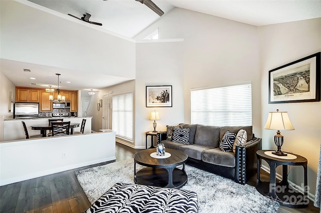 living room with dark hardwood / wood-style flooring, vaulted ceiling, and ceiling fan