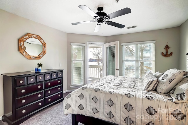 bedroom featuring access to outside, light colored carpet, and ceiling fan