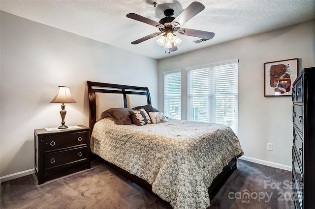 carpeted bedroom with a textured ceiling and ceiling fan