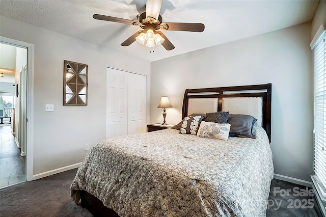 carpeted bedroom with ceiling fan and a closet