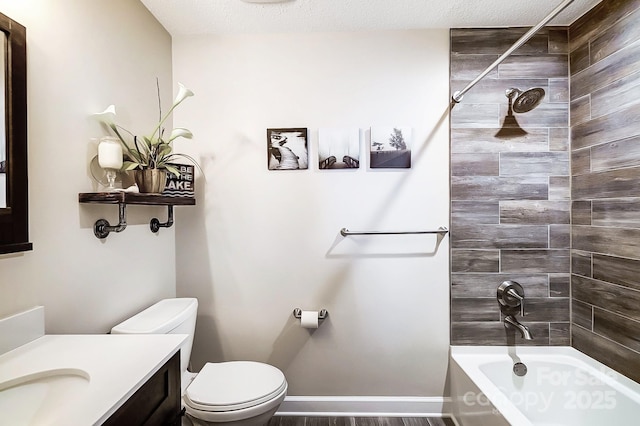 full bathroom with vanity, tiled shower / bath combo, a textured ceiling, and toilet