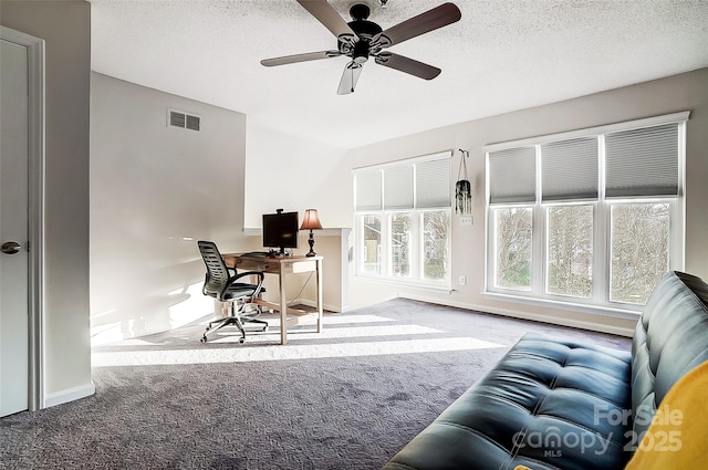 office space featuring ceiling fan, light carpet, and a textured ceiling