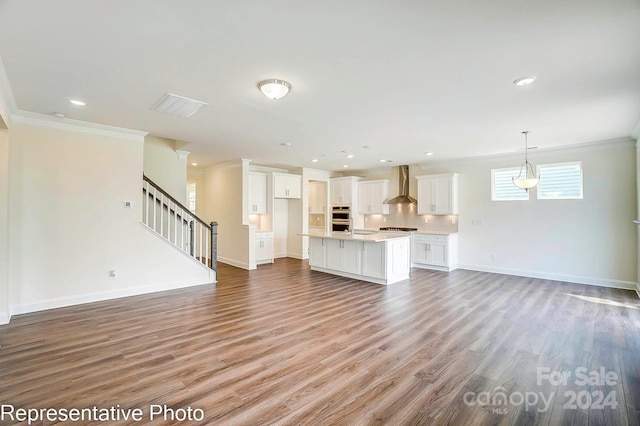 unfurnished living room featuring light wood-type flooring and crown molding