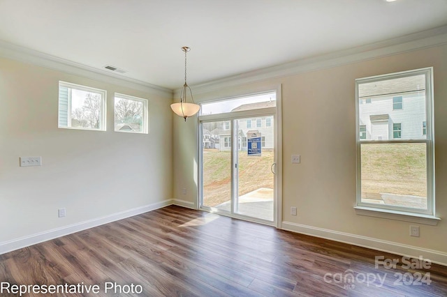 unfurnished dining area with plenty of natural light, wood-type flooring, and ornamental molding