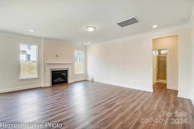 unfurnished living room with dark hardwood / wood-style floors and crown molding