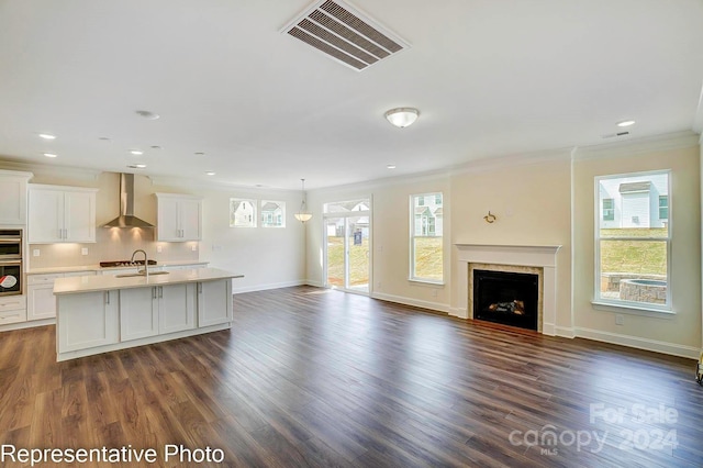 unfurnished living room with dark hardwood / wood-style flooring, a wealth of natural light, ornamental molding, and sink