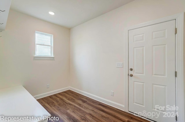 spare room with dark hardwood / wood-style flooring