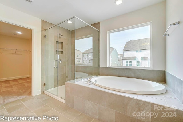 bathroom featuring tile patterned floors and independent shower and bath