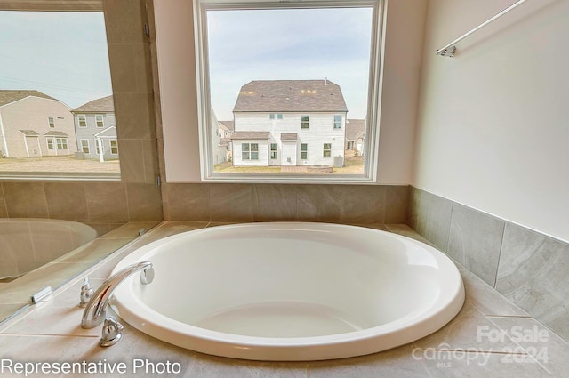 bathroom featuring tiled tub