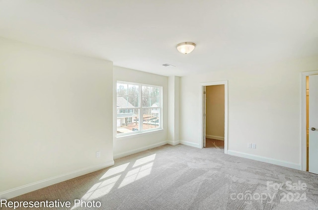 unfurnished room with light carpet