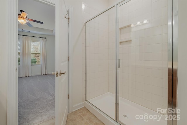 bathroom featuring a shower stall, a ceiling fan, and tile patterned flooring