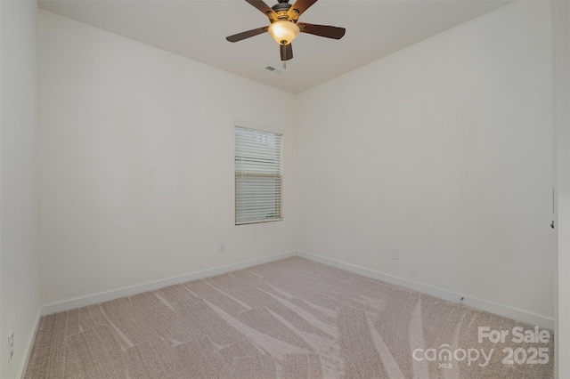 unfurnished room with baseboards, ceiling fan, visible vents, and light colored carpet