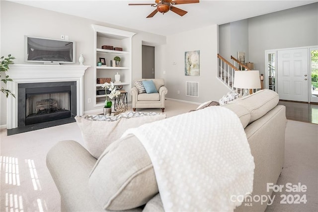 living room with light colored carpet and ceiling fan