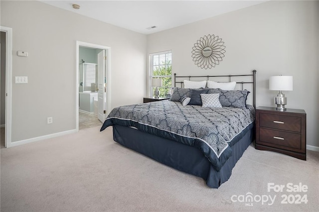 carpeted bedroom featuring ensuite bathroom