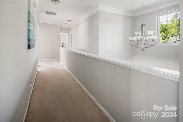 hallway featuring carpet, a notable chandelier, and ornamental molding