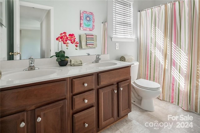 bathroom featuring tile patterned flooring, vanity, and toilet