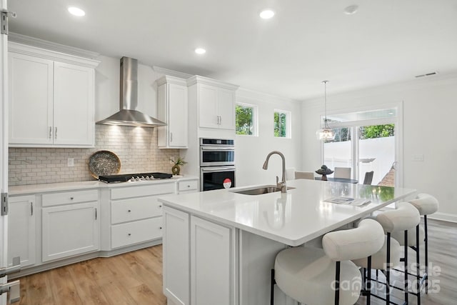 5230 Verona Rd Unit 80, Charlotte, NC 28213 - kitchen with wall chimney range hood, stainless steel double oven, a sink, light wood finished floors, and recessed lighting