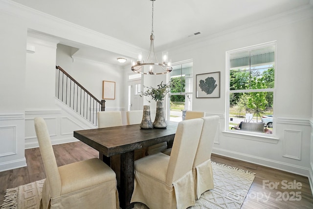 5230 Verona Rd Unit 80, Charlotte, NC 28213 - dining room featuring a chandelier, wood finished floors, a decorative wall, stairway, and a wainscoted wall