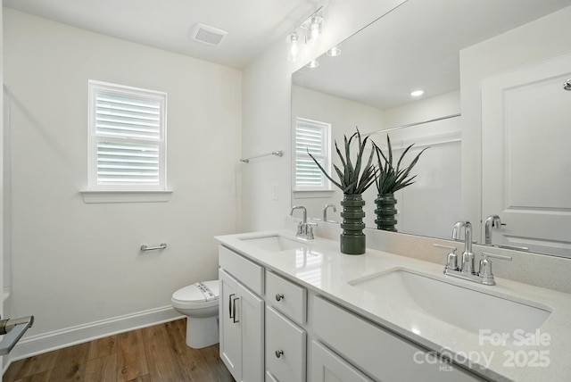 5230 Verona Rd Unit 80, Charlotte, NC 28213 - bathroom with wood finished floors, toilet, double vanity, baseboards, and a shower