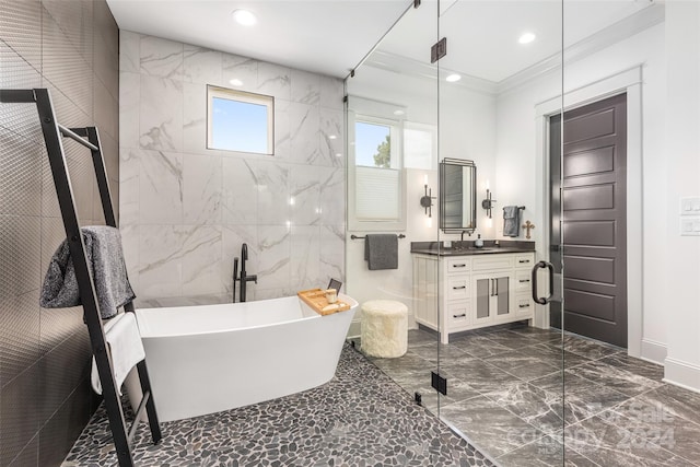 bathroom featuring shower with separate bathtub, vanity, tile walls, and ornamental molding