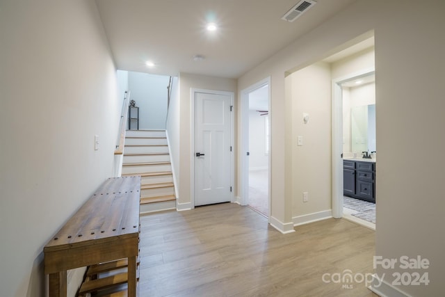 hall with light hardwood / wood-style floors