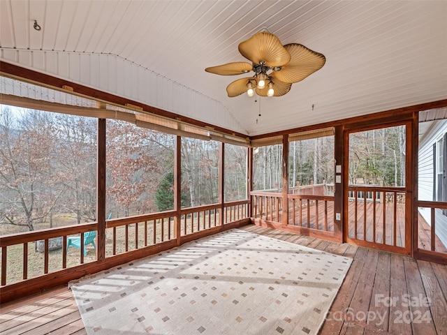 unfurnished sunroom with vaulted ceiling, ceiling fan, and wood ceiling