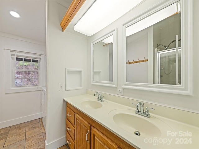 bathroom with tile patterned floors, vanity, and walk in shower