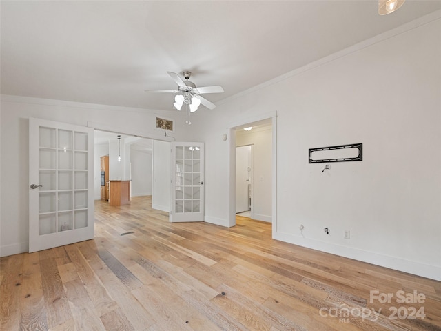 unfurnished room with french doors, hardwood / wood-style flooring, ceiling fan, and crown molding