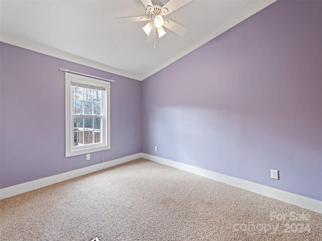 carpeted empty room with ceiling fan and vaulted ceiling