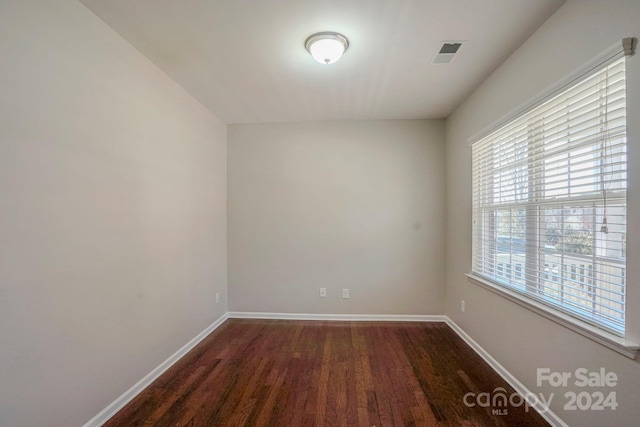 unfurnished room featuring dark hardwood / wood-style flooring