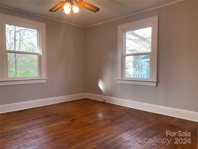 empty room featuring ceiling fan, dark hardwood / wood-style flooring, and ornamental molding