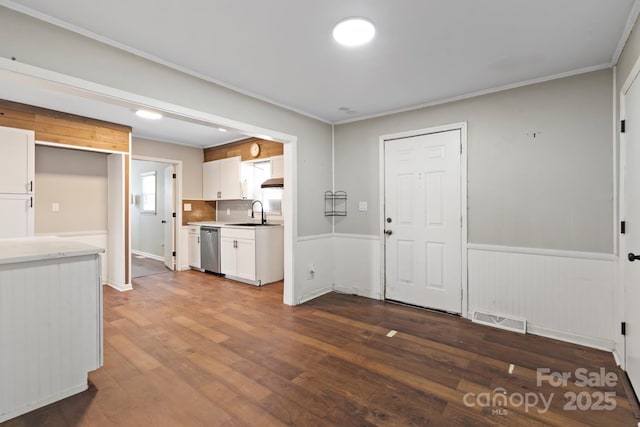 kitchen featuring visible vents, light countertops, stainless steel dishwasher, white cabinets, and dark wood-style flooring