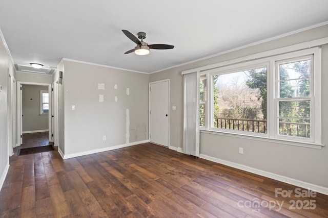 empty room with ceiling fan, baseboards, wood finished floors, and ornamental molding