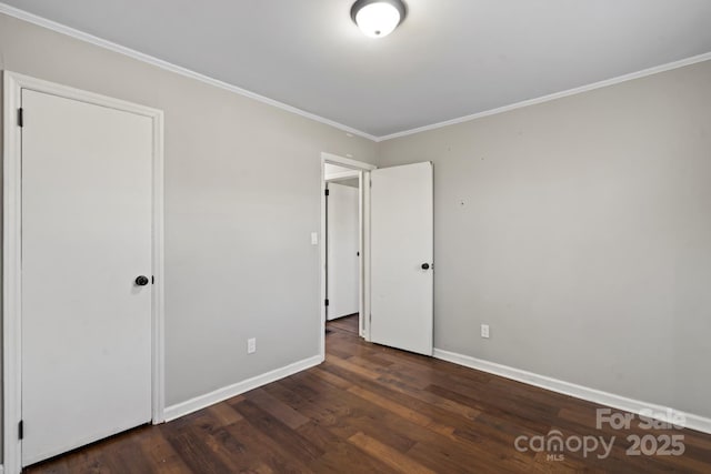 unfurnished bedroom featuring wood finished floors, baseboards, and ornamental molding