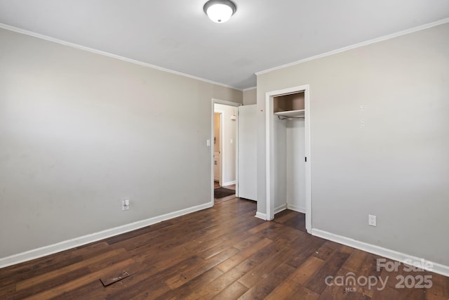 unfurnished bedroom with dark wood-style floors, baseboards, a closet, and ornamental molding