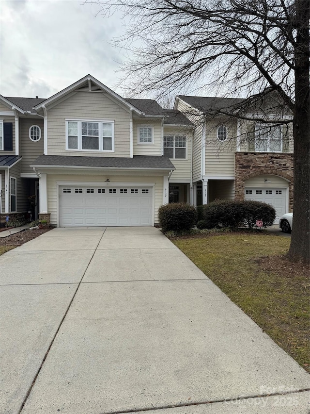 view of front of house with a garage and a front lawn