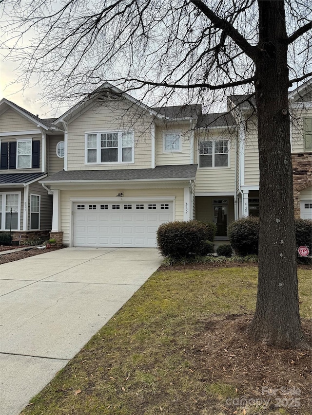 view of front of property with a garage and a front yard