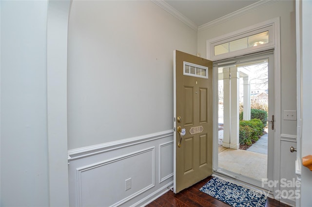 foyer entrance featuring ornamental molding and dark hardwood / wood-style floors