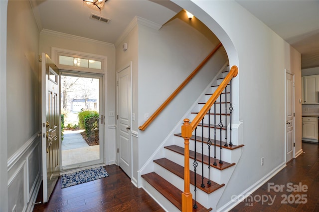 foyer featuring dark wood-type flooring and ornamental molding