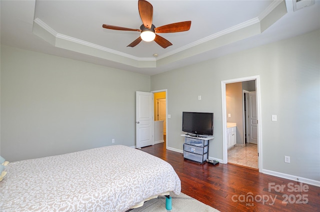 bedroom featuring dark hardwood / wood-style flooring, a tray ceiling, crown molding, and ceiling fan