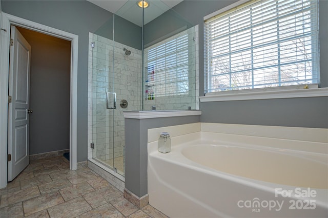 bathroom featuring shower with separate bathtub