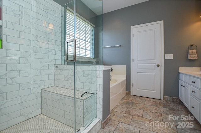 bathroom featuring vanity and separate shower and tub