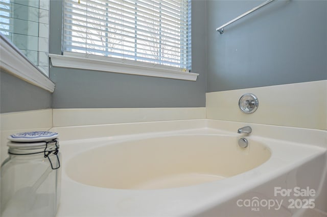 bathroom with a tub to relax in