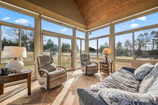 sunroom / solarium with a healthy amount of sunlight and vaulted ceiling