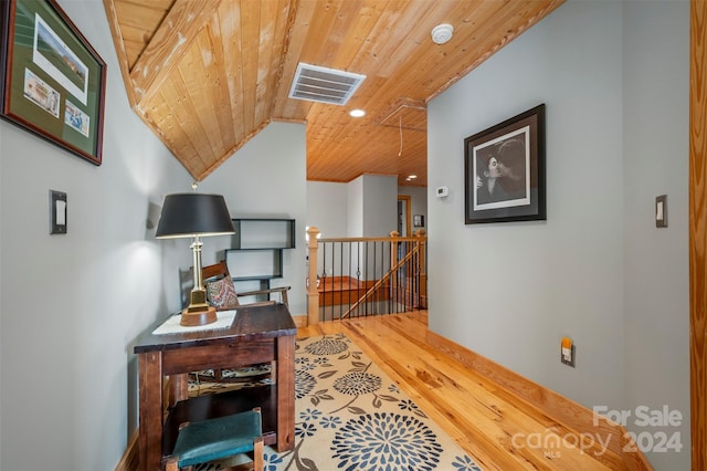 interior space with hardwood / wood-style floors, vaulted ceiling, and wooden ceiling