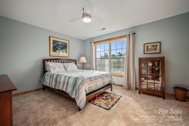 bedroom with ceiling fan and light colored carpet