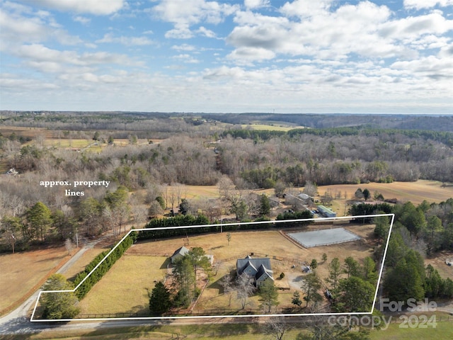 birds eye view of property with a rural view