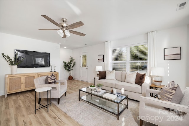 living room featuring ceiling fan and light hardwood / wood-style flooring