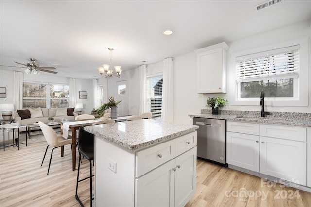 kitchen with white cabinets, ceiling fan with notable chandelier, sink, light hardwood / wood-style flooring, and dishwasher